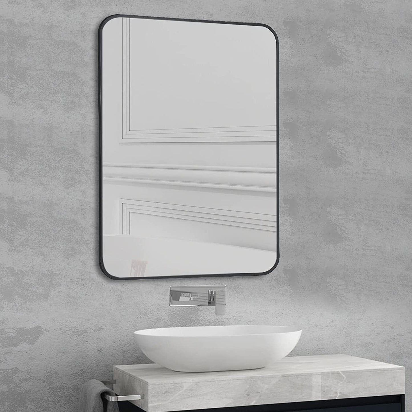 Black Metal Framed Bathroom Wall Mirror With Thin Frame displayed above a modern sink.
