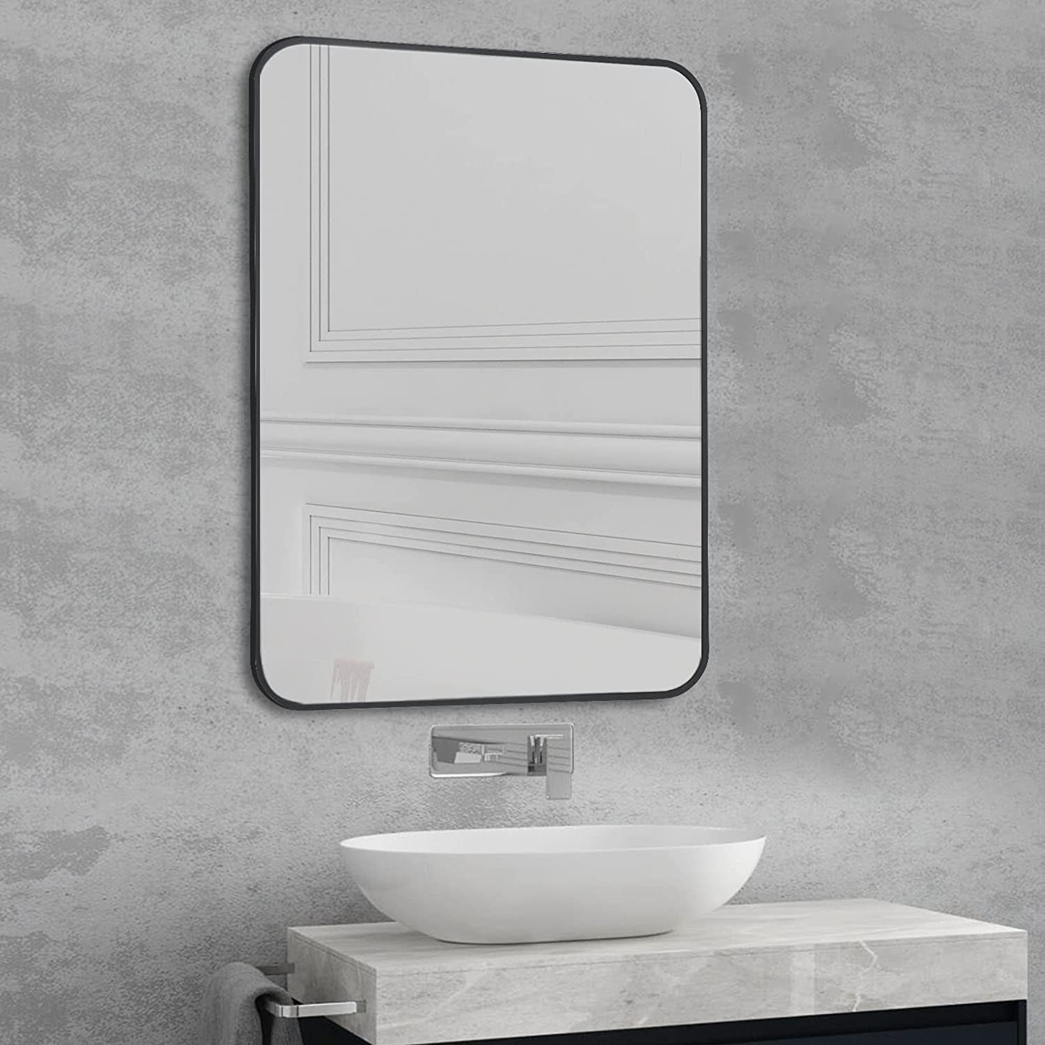 Black Metal Framed Bathroom Wall Mirror With Thin Frame displayed above a modern sink.