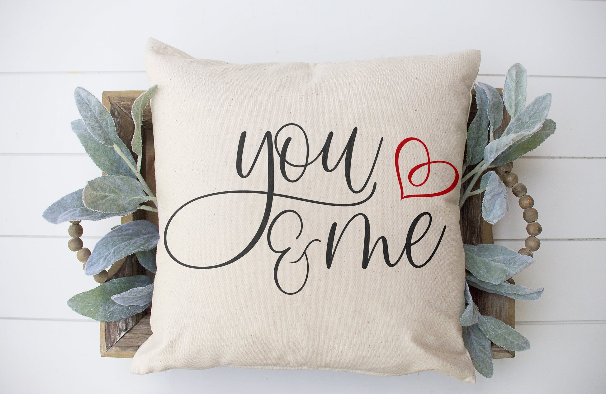 You and Me 18x18 inch Pillow Cover with stylish script writing and a red heart accent on an oatmeal background.