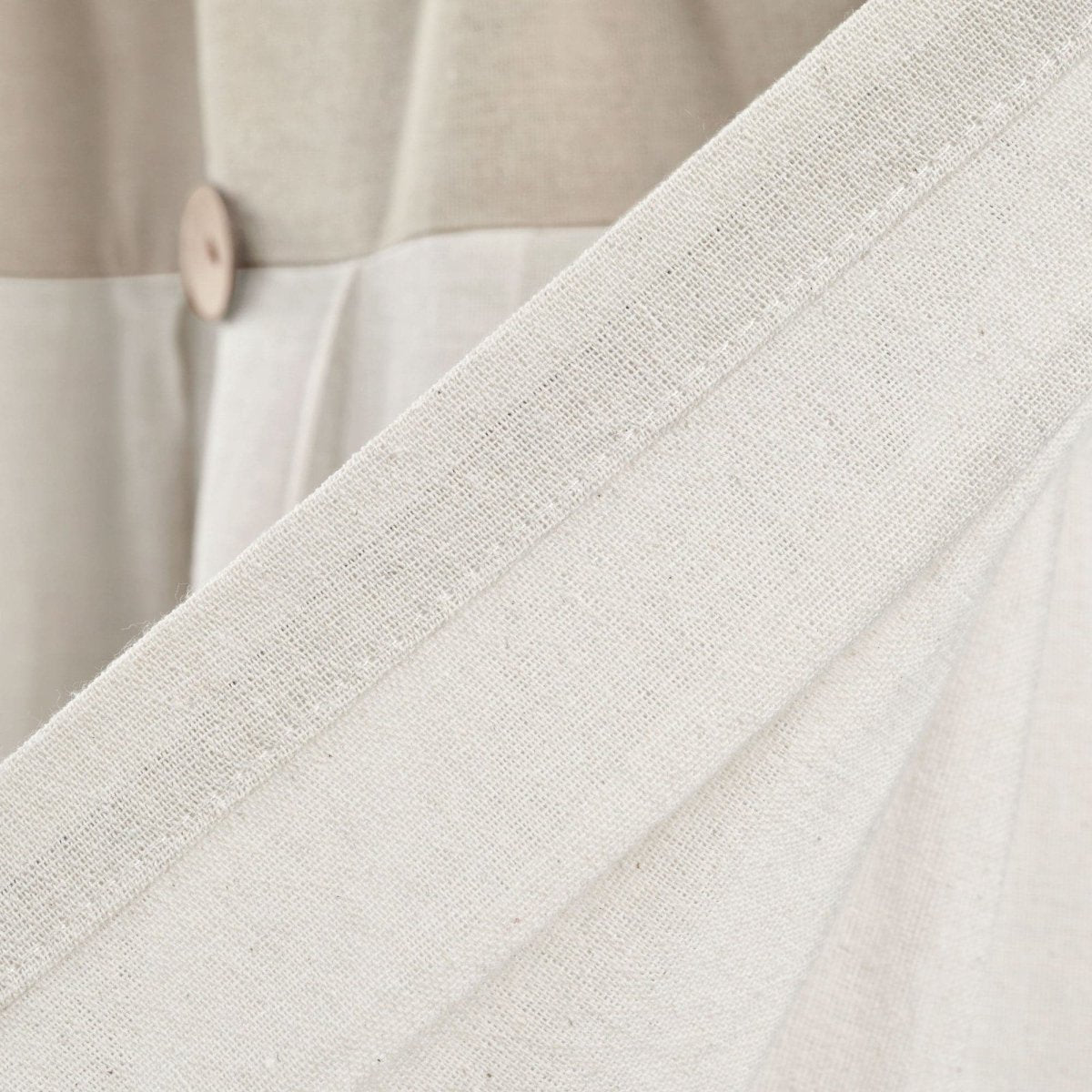 Close-up of a Linen Button Valance showing pleats and buttons, showcasing the elegant linen texture and color blocking.