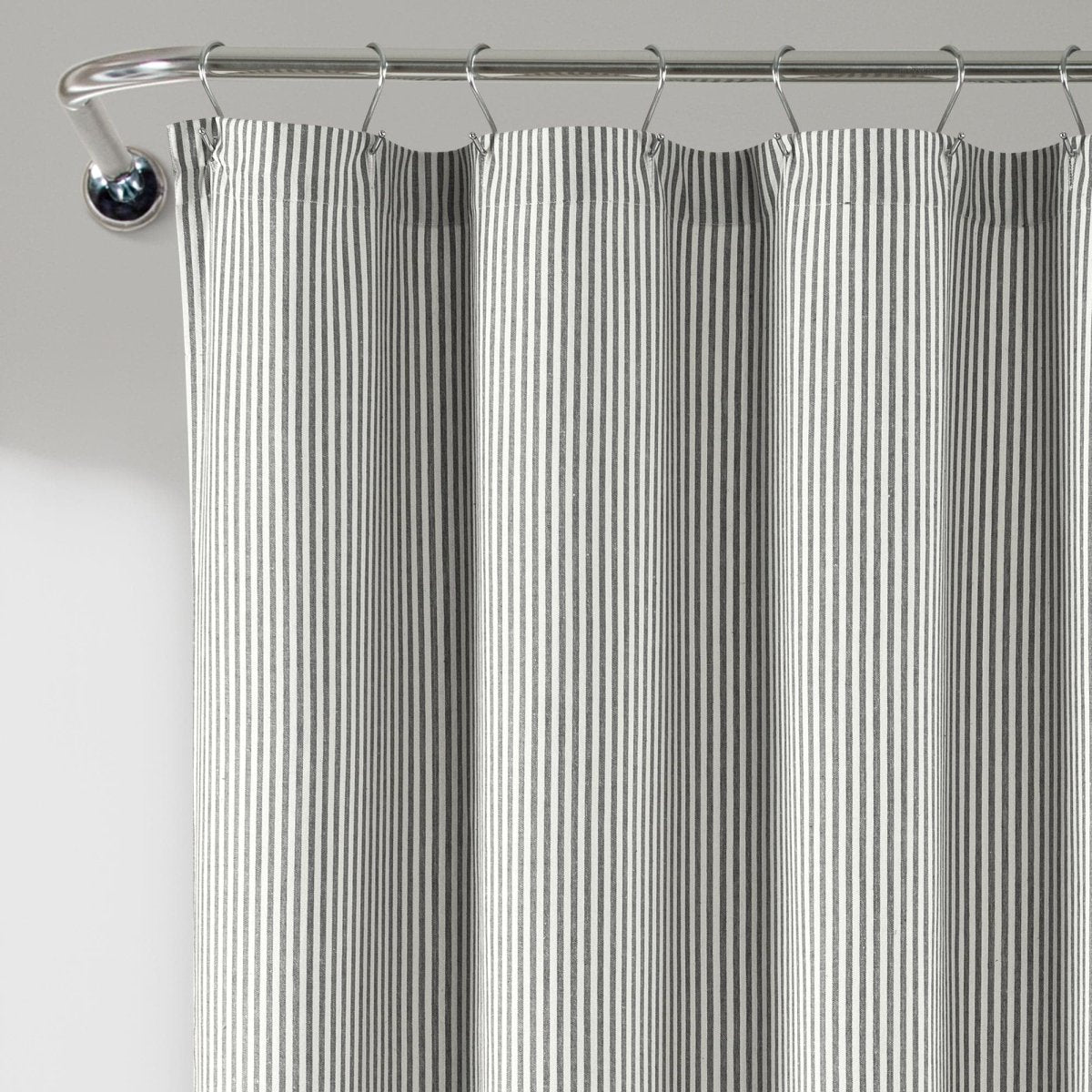Farmhouse Vintage Stripe Yarn Dyed Recycled Cotton Blend Shower Curtain hanging on a rod for a cozy bathroom atmosphere.