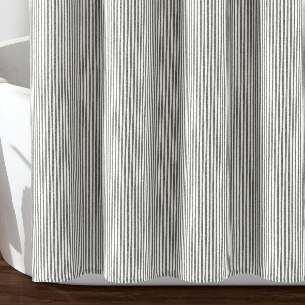 Farmhouse Vintage Stripe Yarn Dyed Recycled Cotton Blend Shower Curtain close-up hanging beside a bathtub.