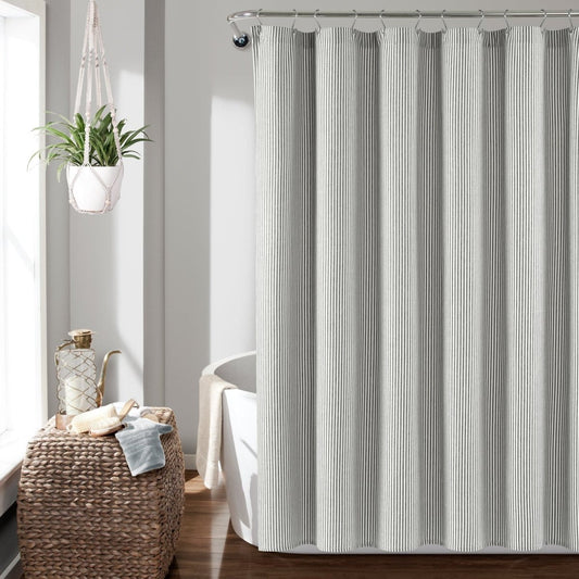 Farmhouse Vintage Stripe Yarn Dyed Recycled Cotton Blend Shower Curtain hanging in a bright bathroom setting.