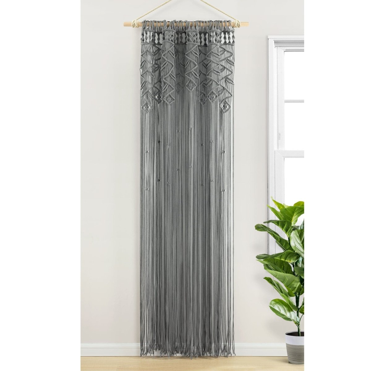 Boho Macrame Leaf Cotton Window Curtain showcasing intricate knots and flowy fringe, filtering natural light.