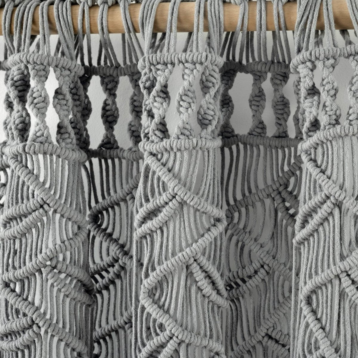 Close-up of the intricate design of Boho Macrame Leaf Cotton Window Curtain showcasing grey cotton knots and fringe.