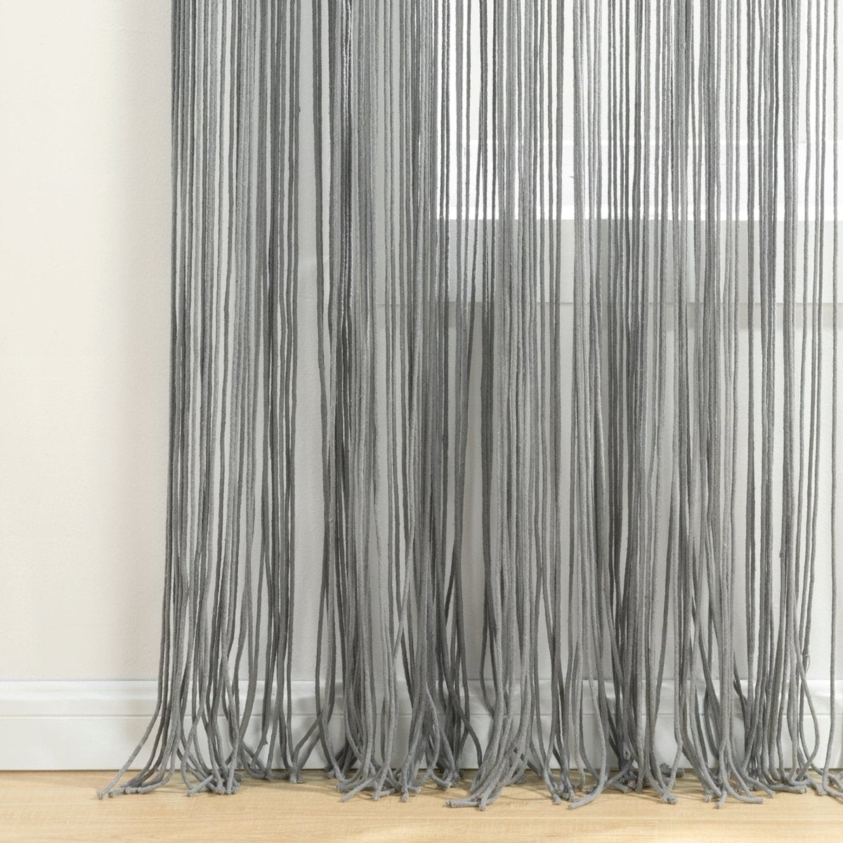 Boho Macrame Leaf Cotton Window Curtain showcasing gray cascading fringe design filtering natural light.