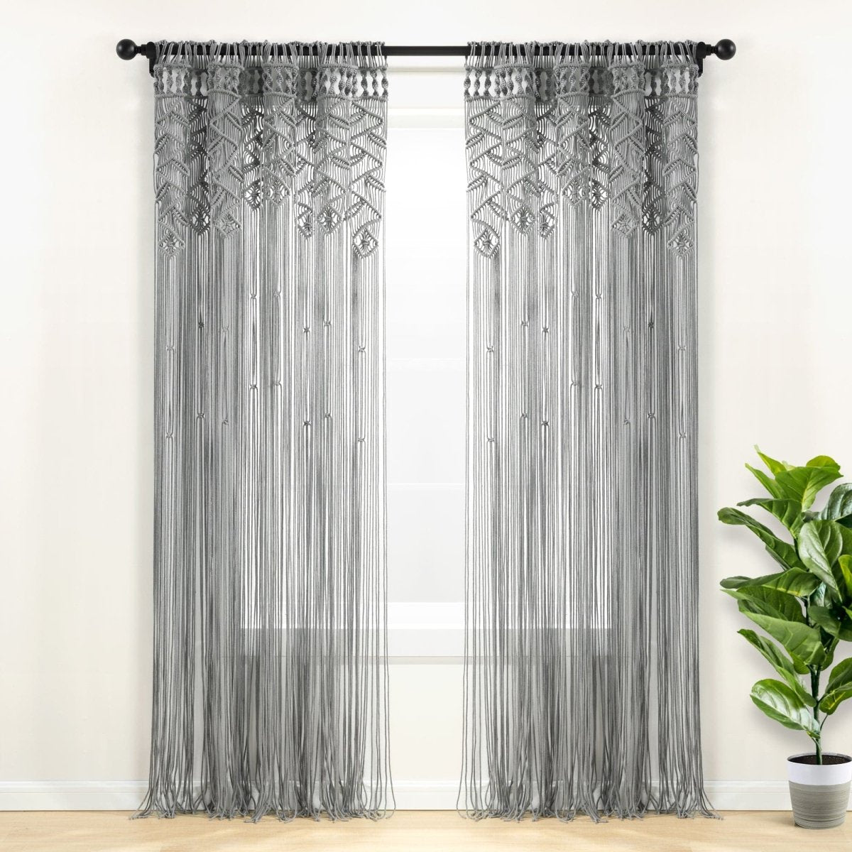 Boho Macrame Leaf Cotton Window Curtain showcasing intricate knot patterns and flowy fringe, enhancing natural light in a stylish interior.