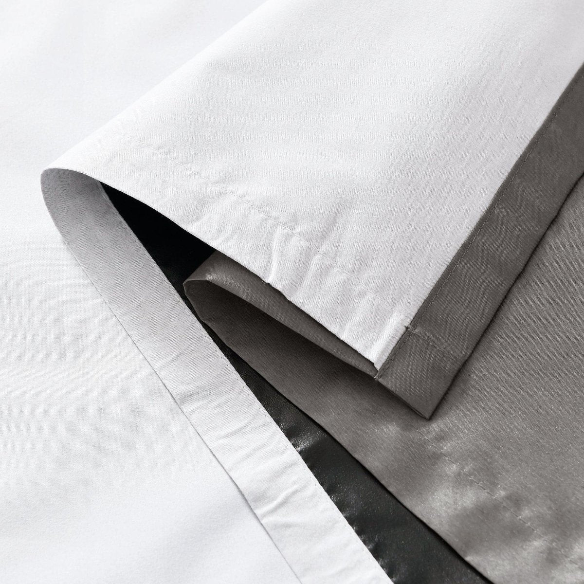 Close-up of the edge of a Faux Silk 100% Blackout Window Curtain showing the smooth texture and luxurious fabric.