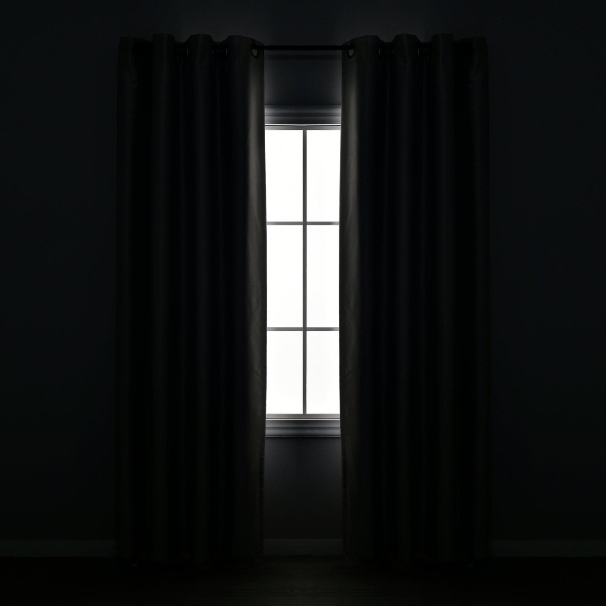 Blackout Window Curtain in a dark room with a window, showcasing complete privacy and elegant design.