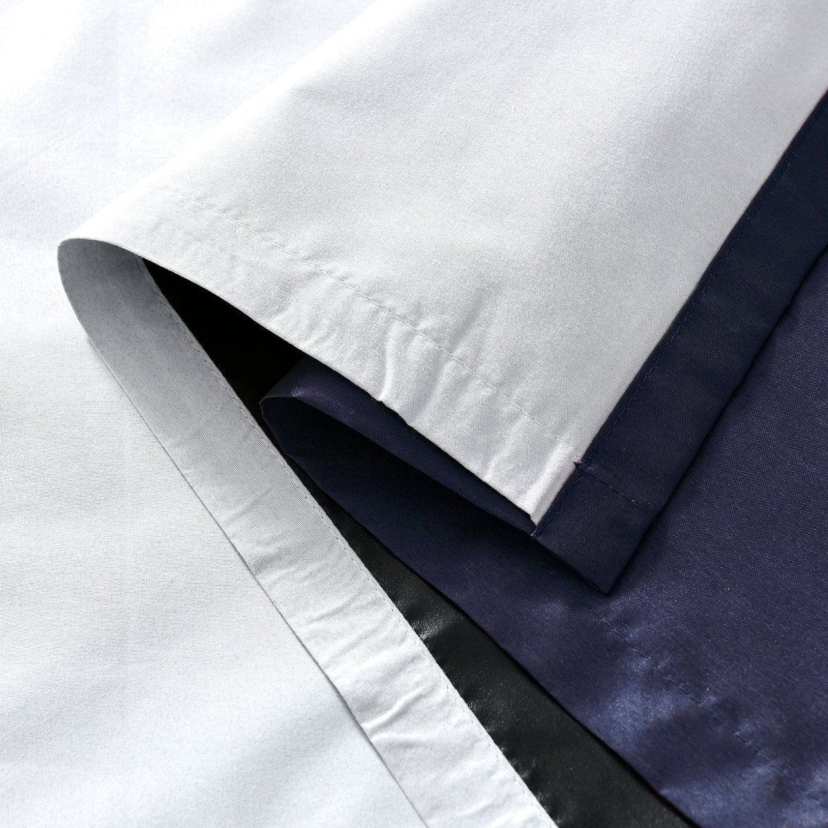 Close-up of Faux Silk 100% Blackout Window Curtain fabric showcasing smooth texture and solid colors.