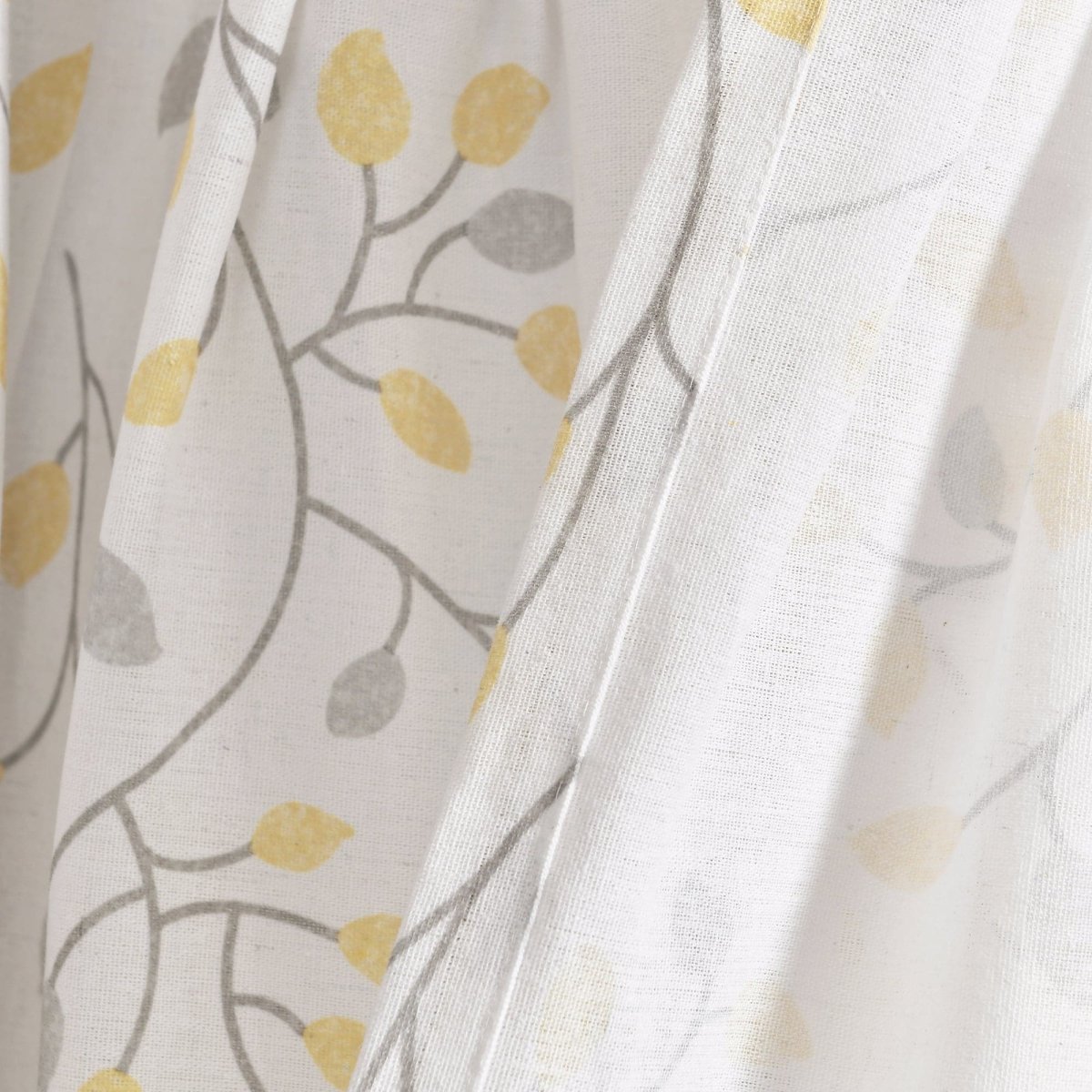 Linen Button Botanical Garden Window Curtain fabric detail featuring yellow and gray leaf patterns on a light background.