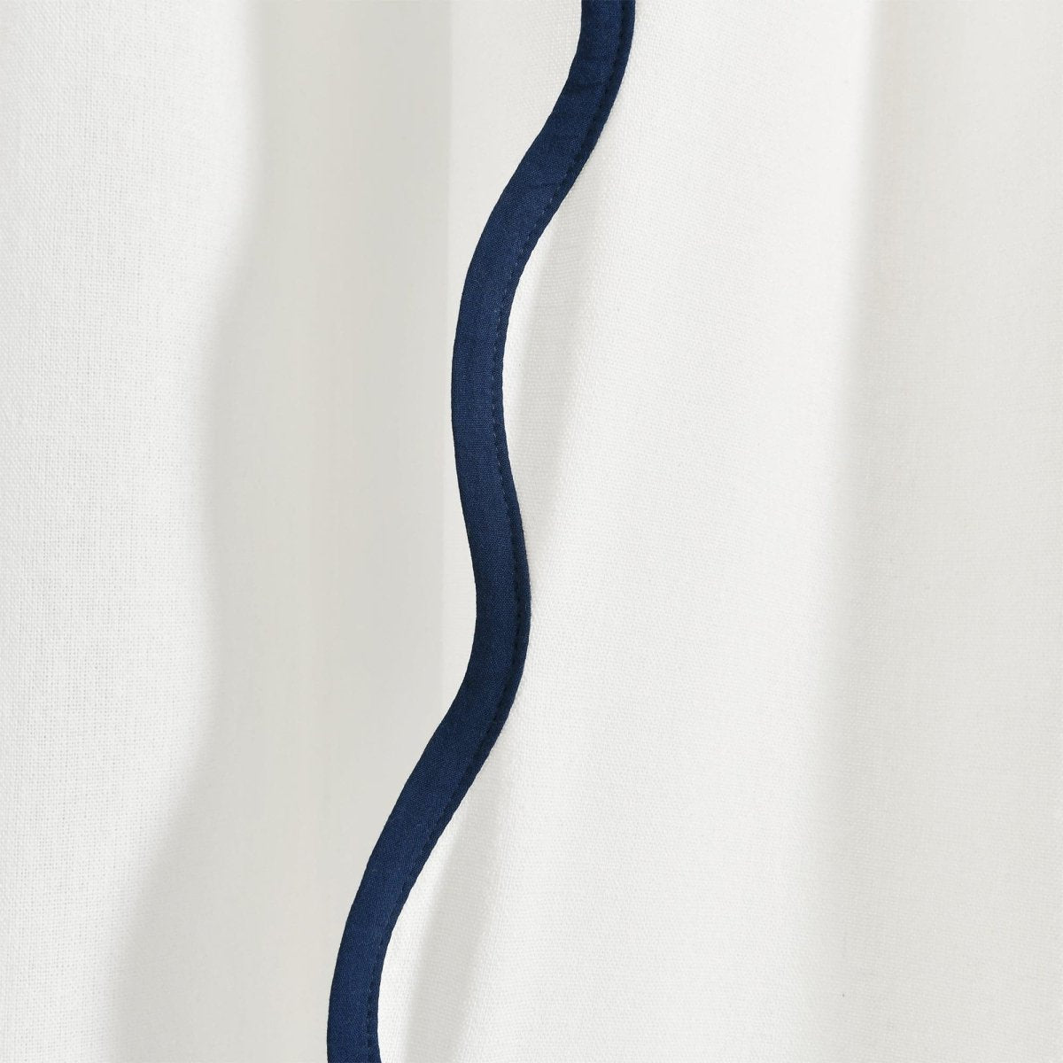 Coastal Chic Scalloped Edge Window Curtain Panel Set featuring a wavy navy trim detail on a white fabric backdrop.