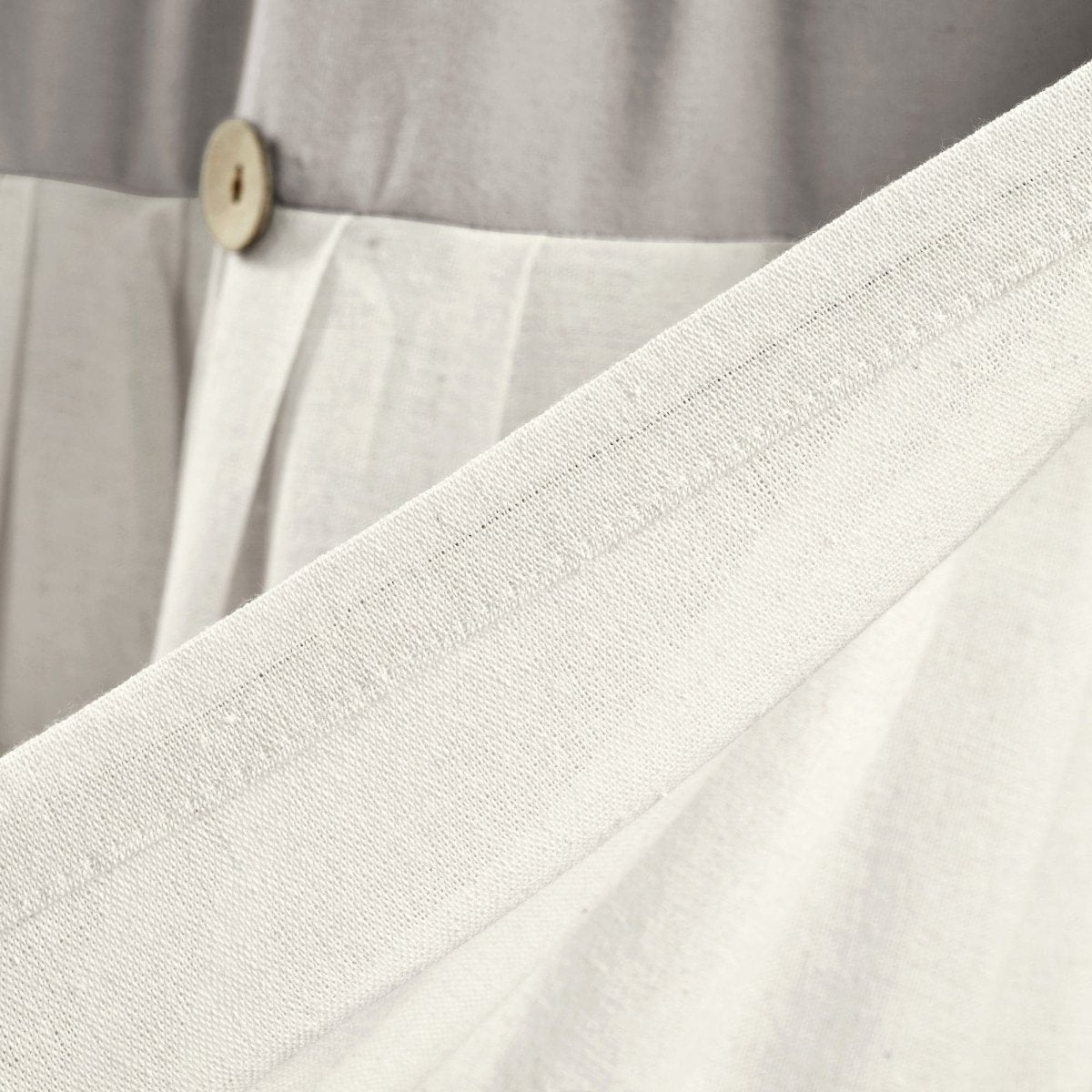 Close-up of Linen Button Valance showcasing pleats and button details in a natural fiber blend.