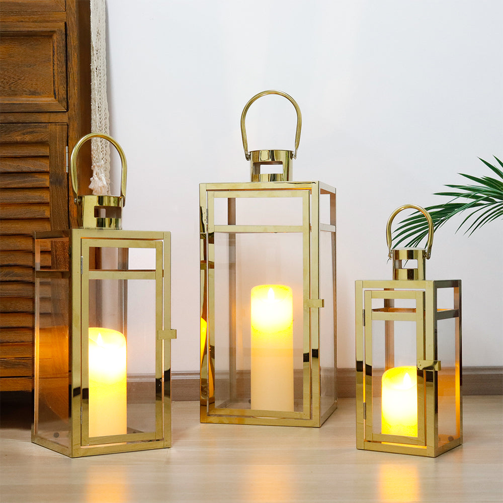 Set of 3 Stainless Steel Lanterns Gold with candles glowing inside, perfect for home decor and events.