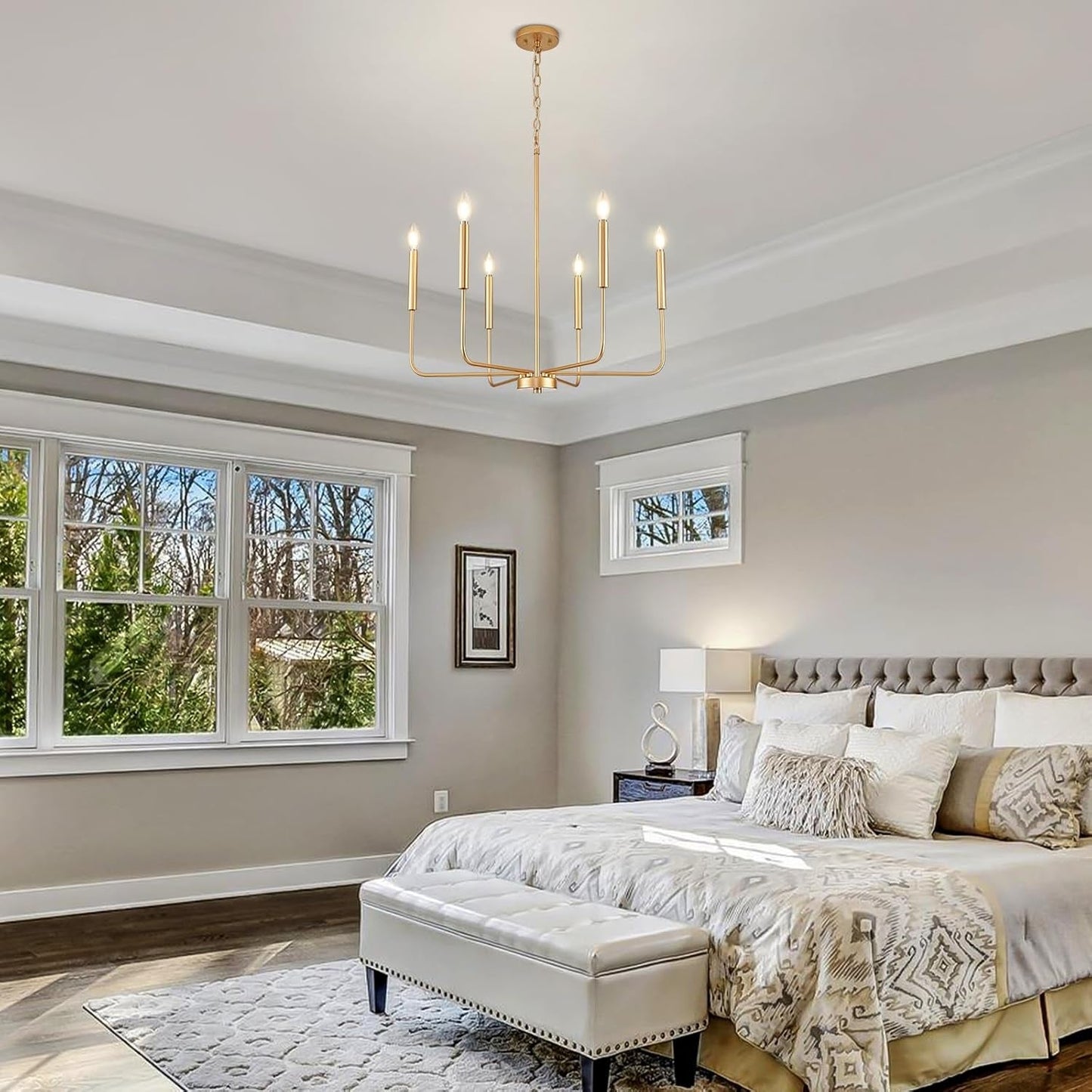 Gold 6 Light Candle Chandelier For Dining Room Modern hanging in a stylish and bright bedroom setting.