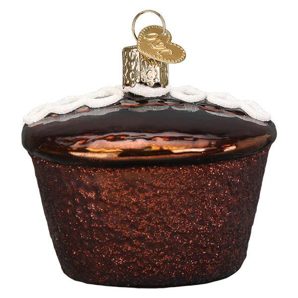 Decorative glass ornament shaped like a cupcake with brown frosting on a white background