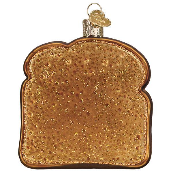 Glass ornament shaped like a slice of bread with a gold finish on a white background