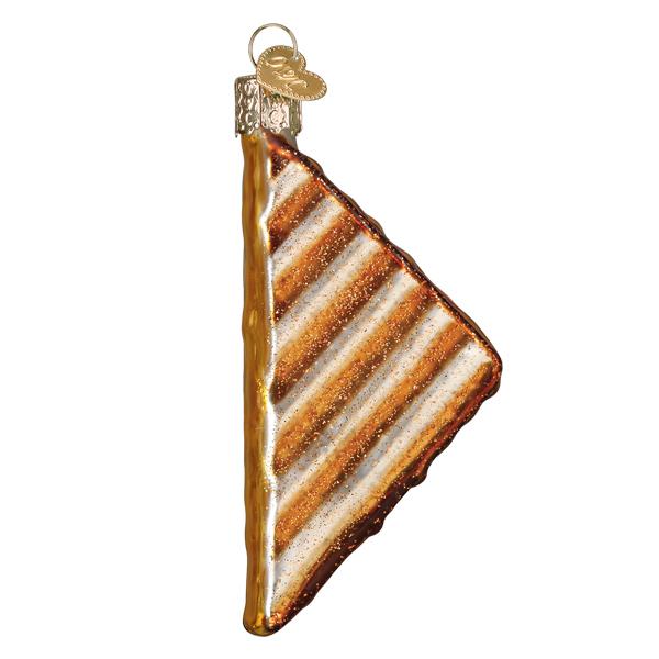 Glass ornament shaped like a grilled cheese sandwich on a white background