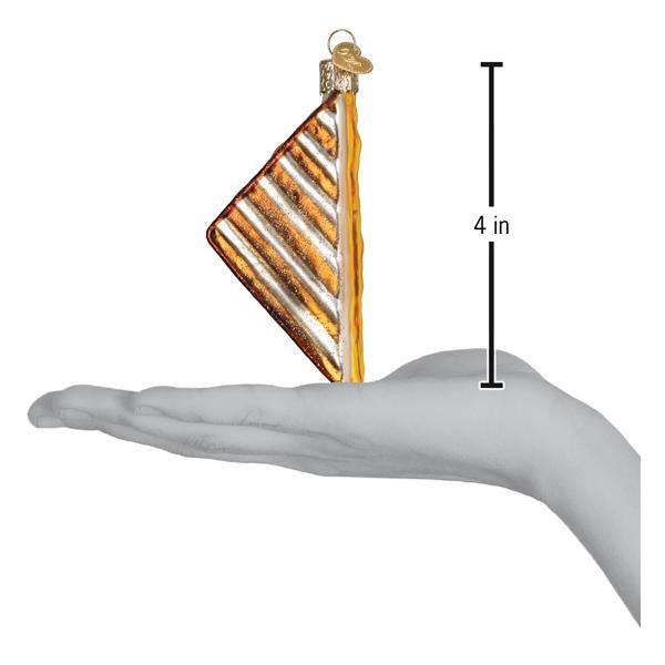 Decorative glass ornament with striped design held in a hand for scale, showing it is approximately 4 inches tall.