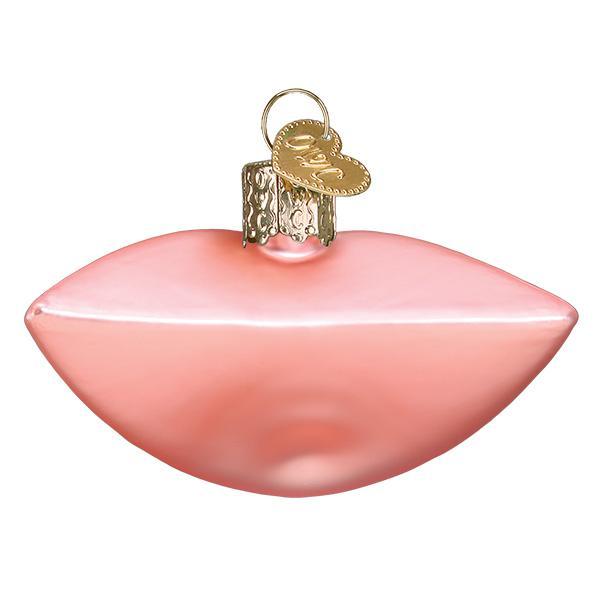 Pink lip-shaped ornament with a gold tag on a white background