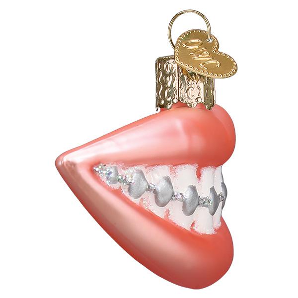 Decorative ornament shaped like a mouth with teeth and braces on a white background