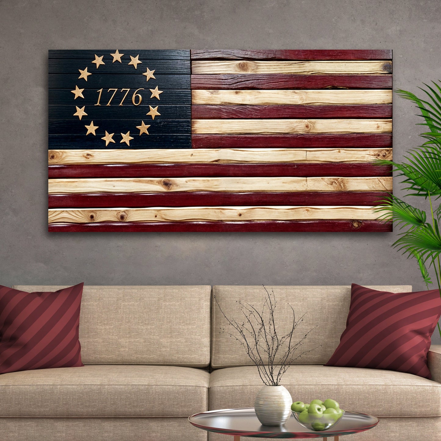 Wooden flag with '1776' on a wall above a beige sofa.