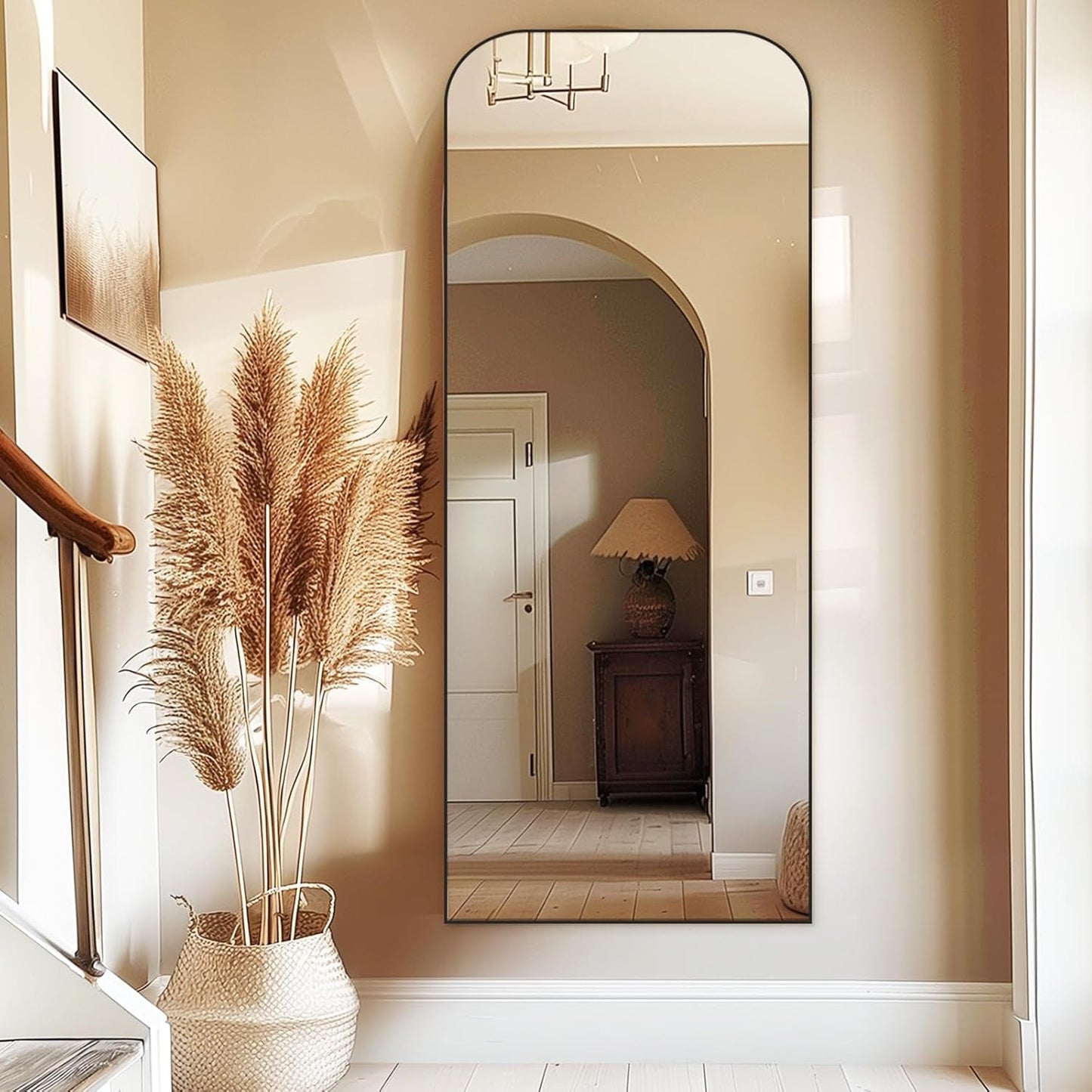 71 Inch Black Oversized Full Length Arch Floor Mirror reflecting stylish hallway decor and plants.