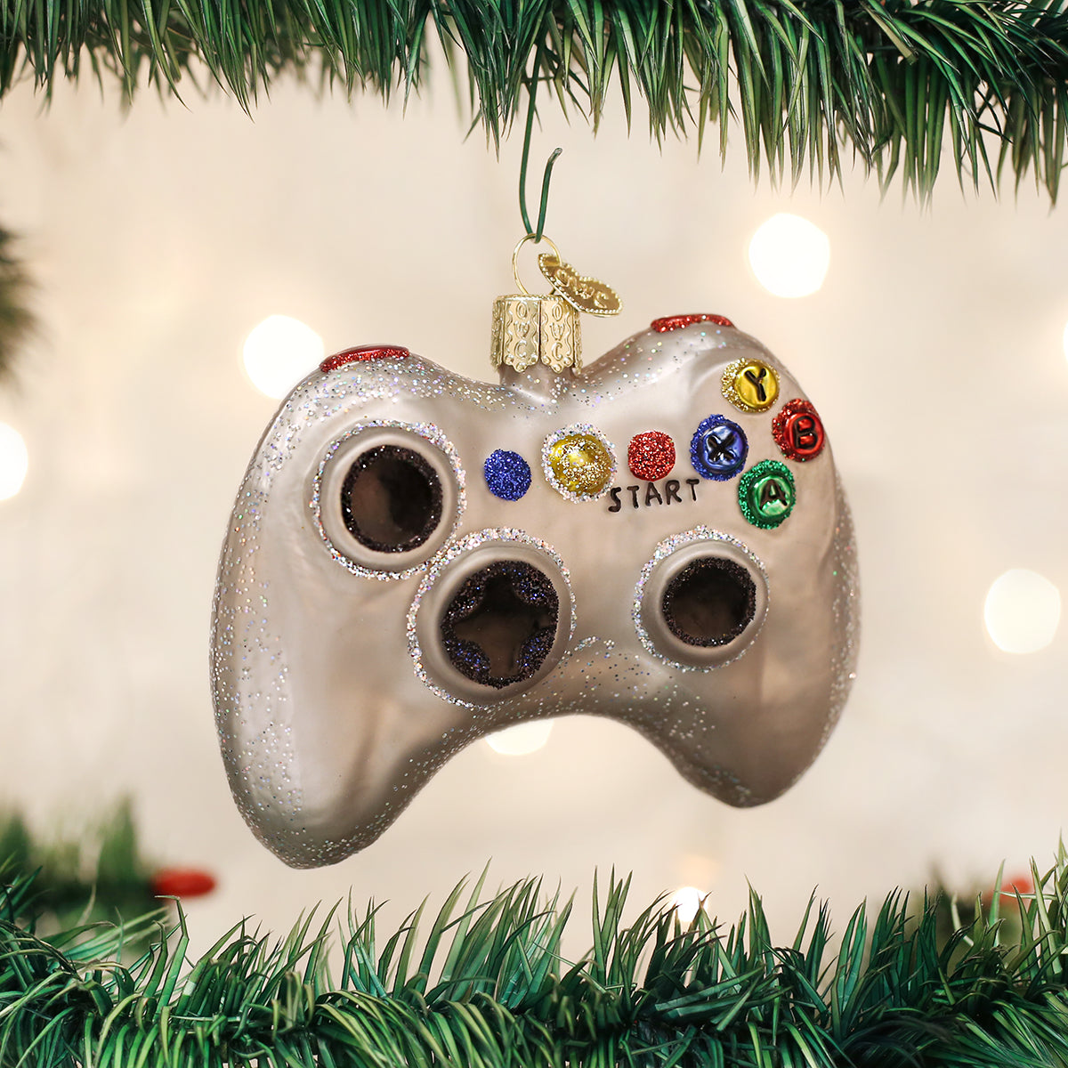 Gaming controller ornament hanging on a Christmas tree with lights in the background