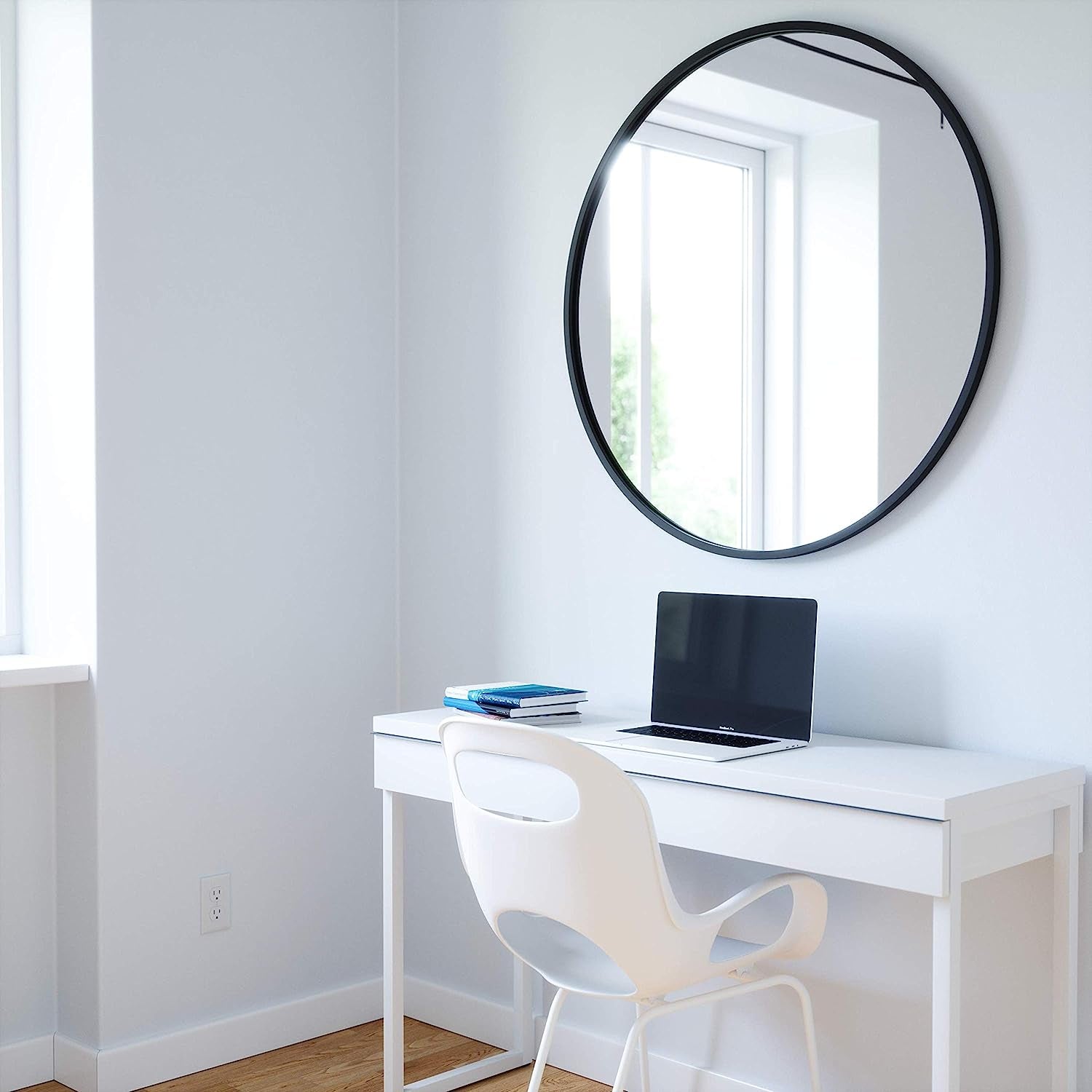 Round Rubber Wall Mirror 37 Inch displayed above a modern white desk with laptop and books.