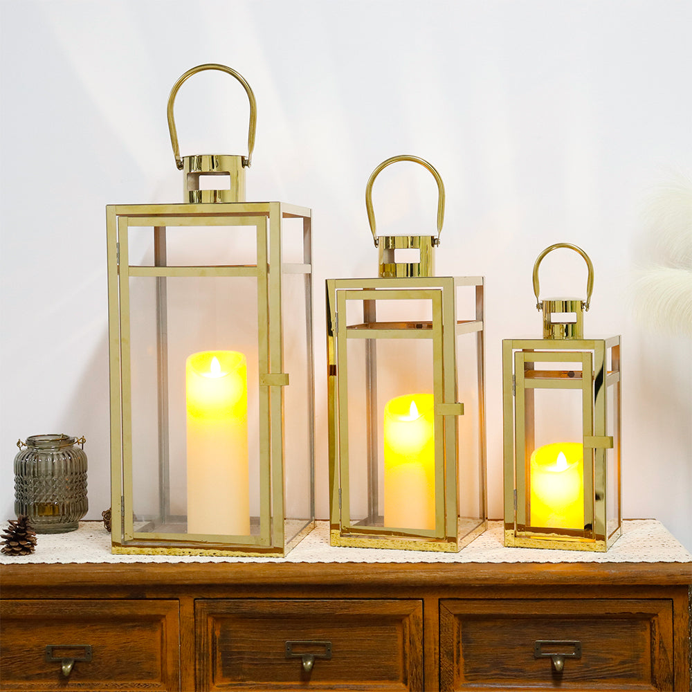 Set of 3 Stainless Steel Lanterns Gold with illuminated candles, showcasing versatile design for various decor styles.