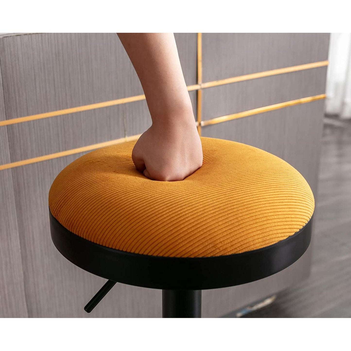 Yellow Fabric Swivel Bar Stool Set Of 2 Height Adjustable with soft corduroy cushion being pressed.