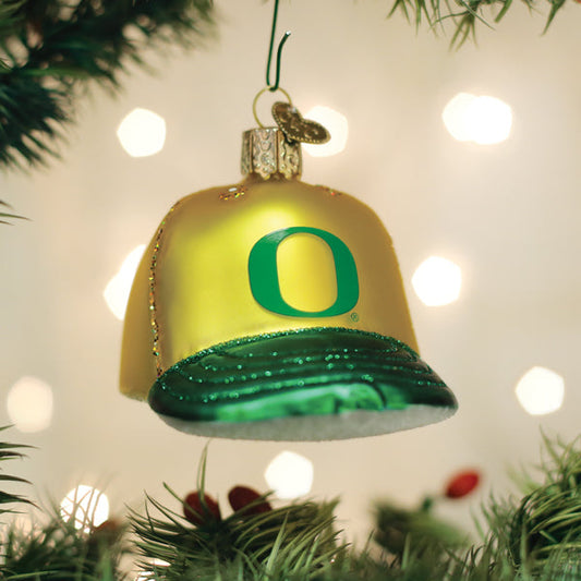 Christmas ornament shaped like a bell with a green 'O' on a decorated tree.
