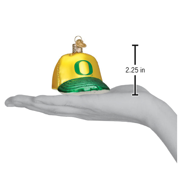 Oregon Baseball Cap Ornament held in a hand, measuring 2.25 inches in size.