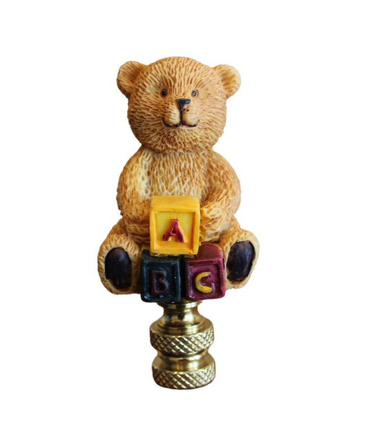 Teddy Bear Decorative Lamp Finial featuring a bear sitting on colorful blocks with an antique brass base, 2.75" height.