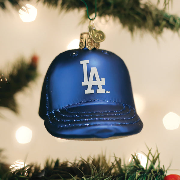 Dodgers Baseball Cap Ornament hanging on a Christmas tree decorated with lights.