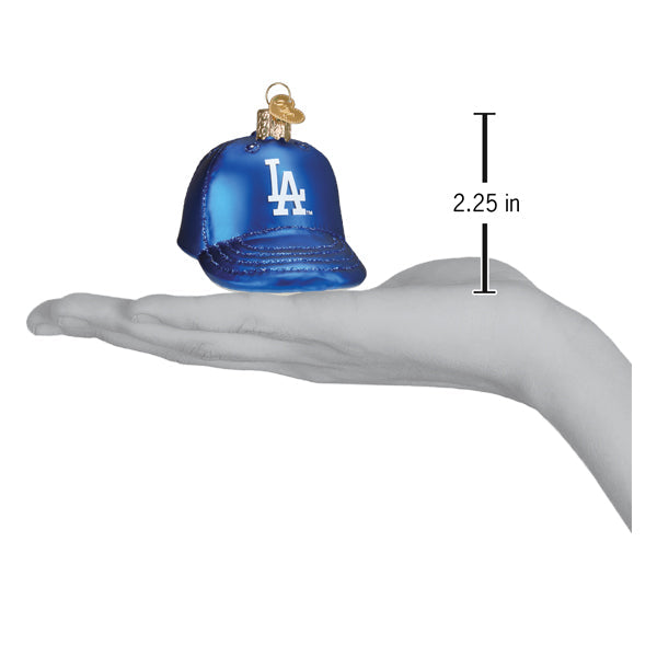 Dodgers Baseball Cap Ornament in hand, showing size of 2.25 inches, blue with LA logo, perfect for baseball fans.