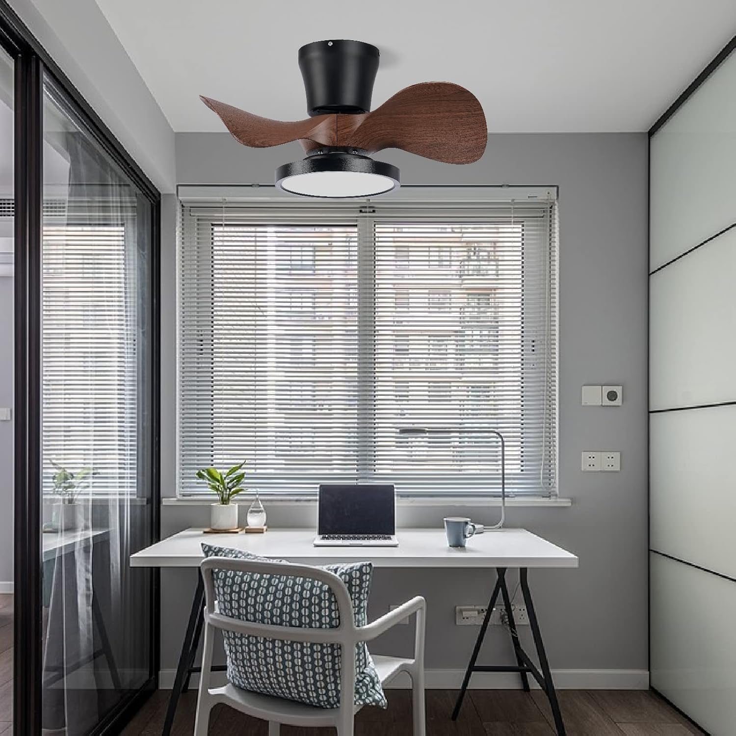 Modern home office with a desk, chair, and ceiling fan.