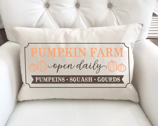 Pumpkin Farm Open Daily Pillow Cover 12x20 inch with pumpkins and text on a cozy sofa.