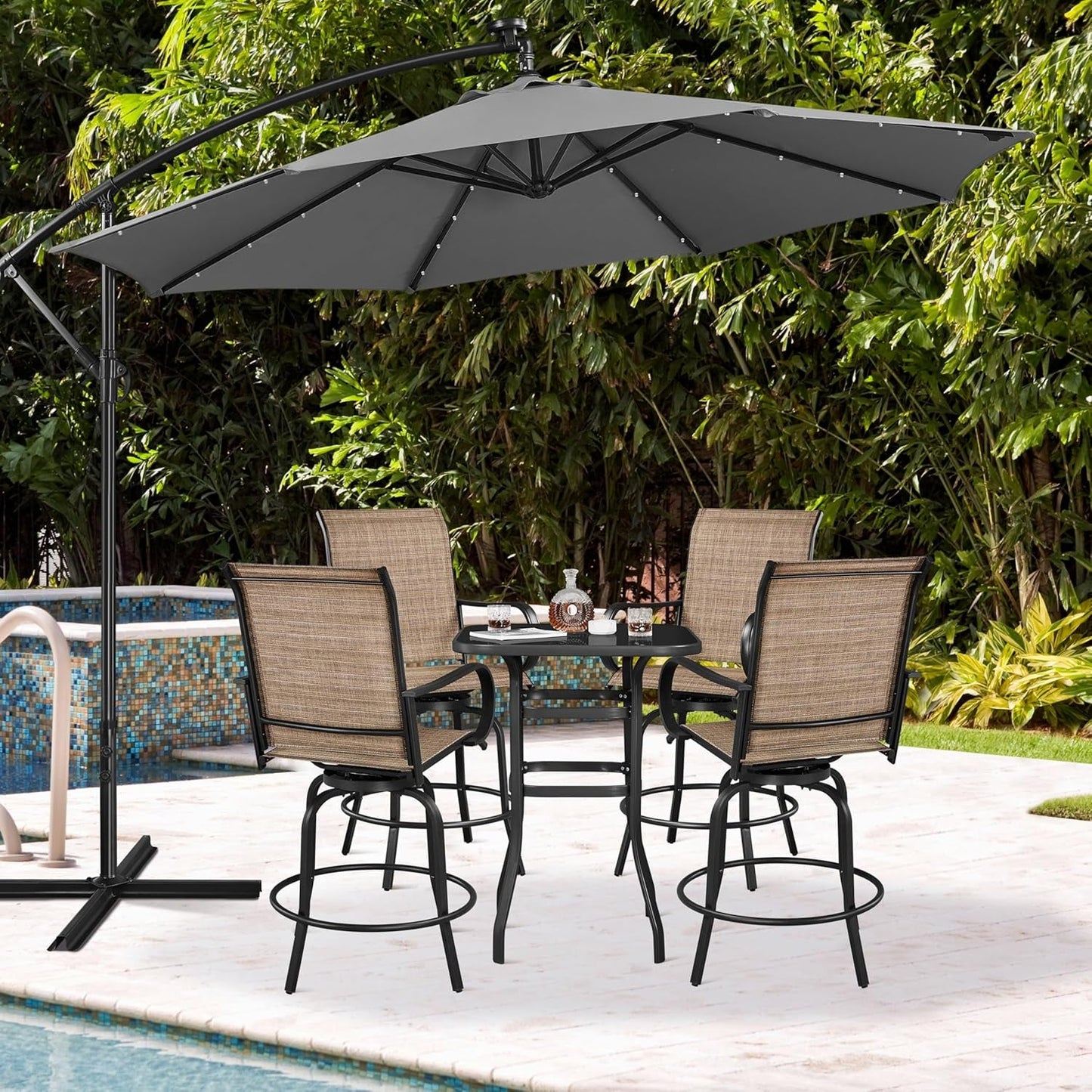 Outdoor Swivel Barstools Set of Four arranged around a patio table under a large umbrella.