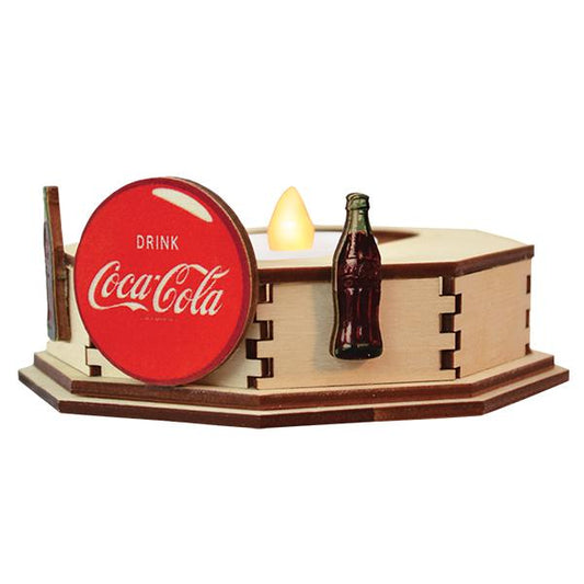 Wooden tealight holder with Coca-Cola sign and bottle on a white background
