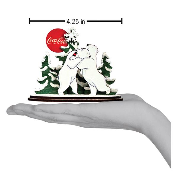 Coca-Cola polar bear figurine with trees and a red circle on a white background