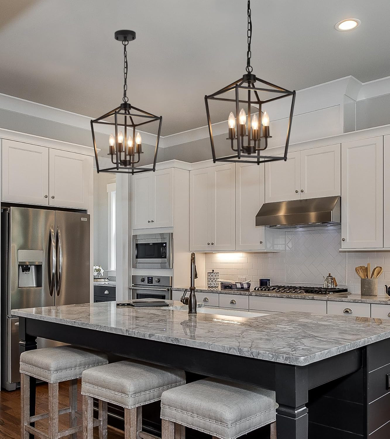 UL Black Industrial Lantern Chandelier 4 Light Pendant illuminating a modern kitchen with white cabinets and a marble island.