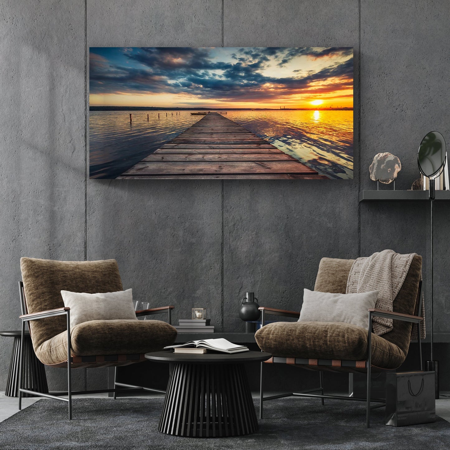 Modern living room with two armchairs, a coffee table, and a large sunset over water painting on the wall.