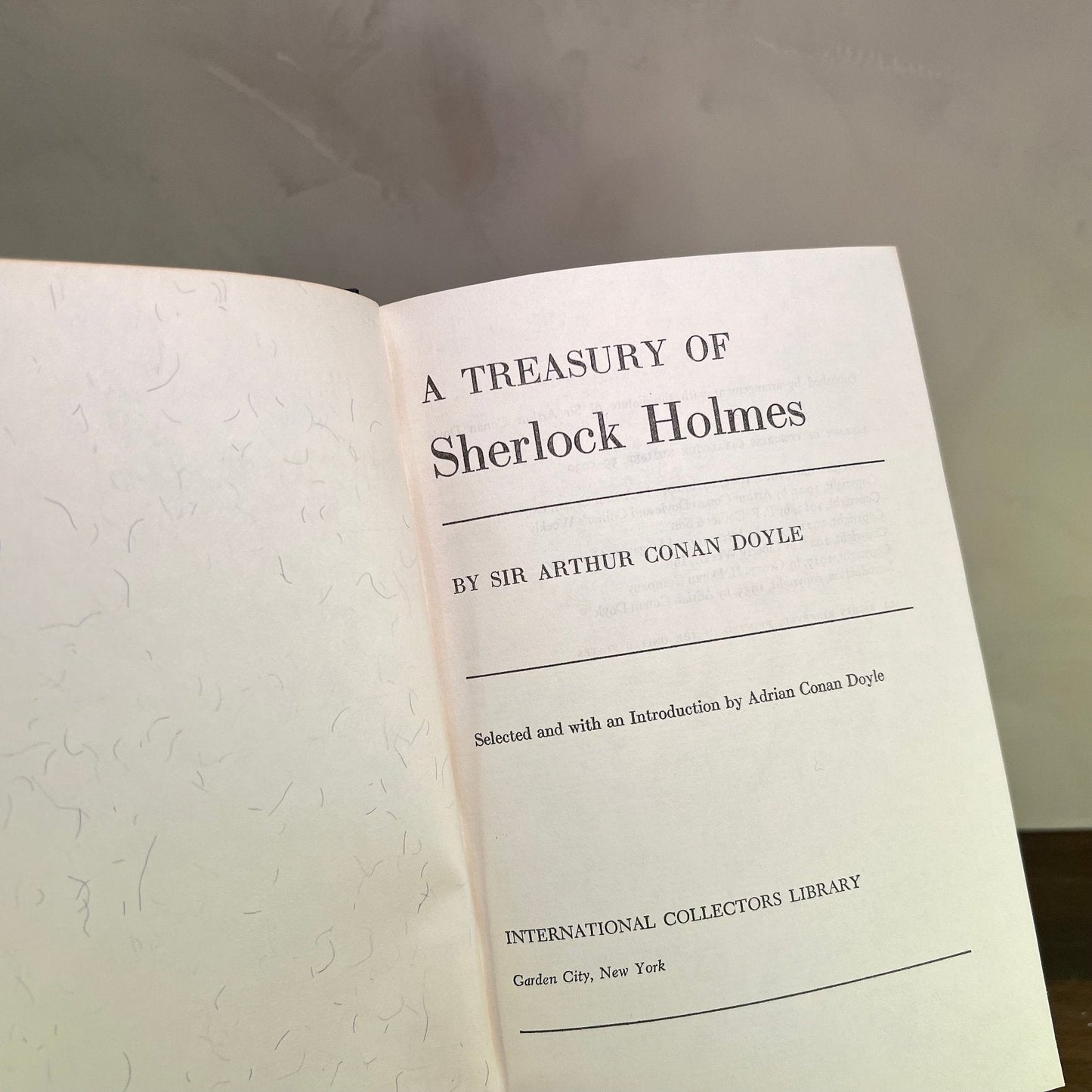 A Treasury of Sherlock Holmes book page by Sir Arthur Conan Doyle in a collector's edition.