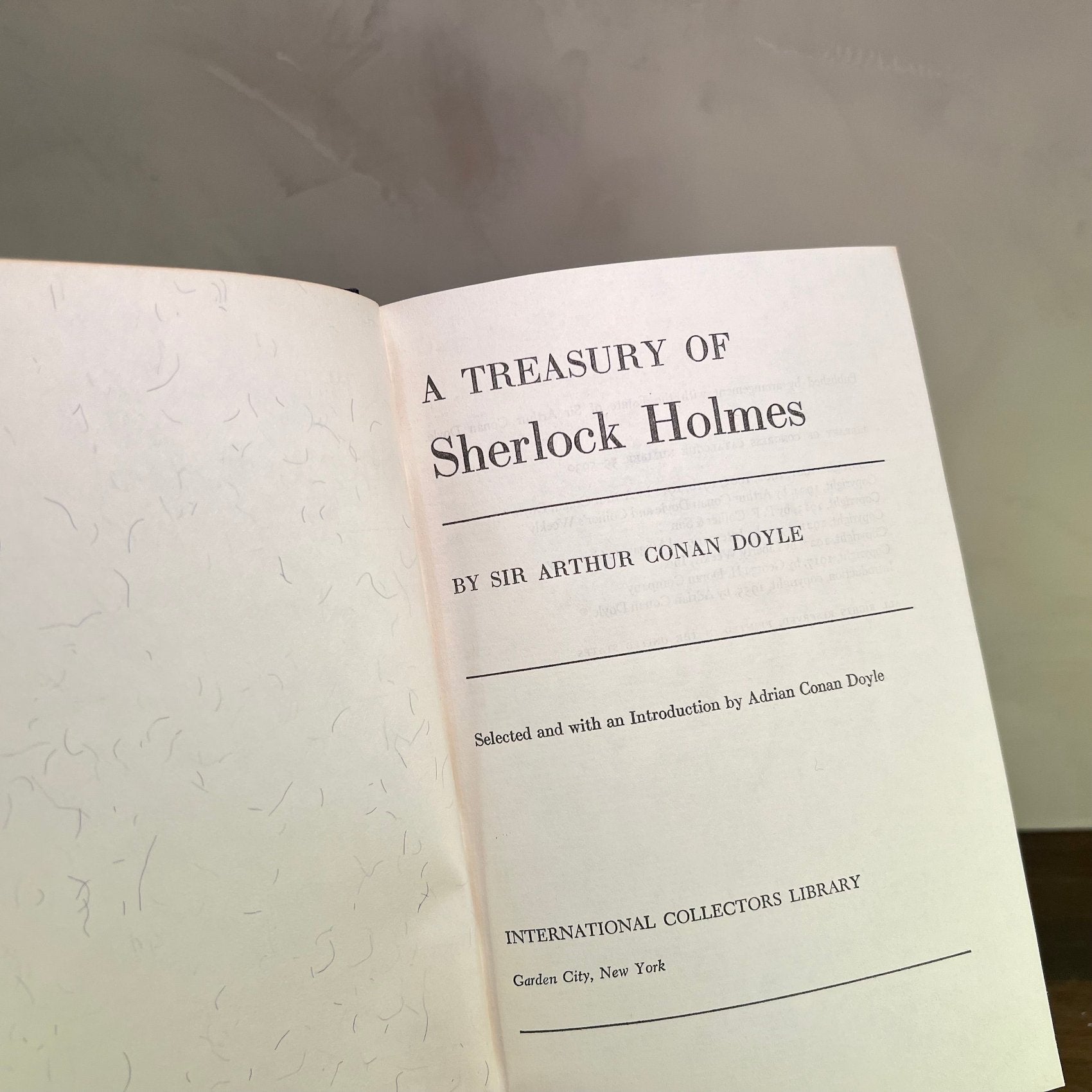 A Treasury of Sherlock Holmes book page by Sir Arthur Conan Doyle in a collector's edition.