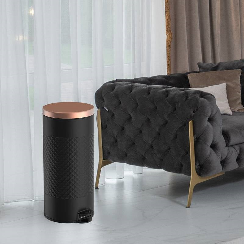 Hands Free Black Gold Metal Step On Trash Can 8 Gallons next to a stylish grey couch in a modern living room.