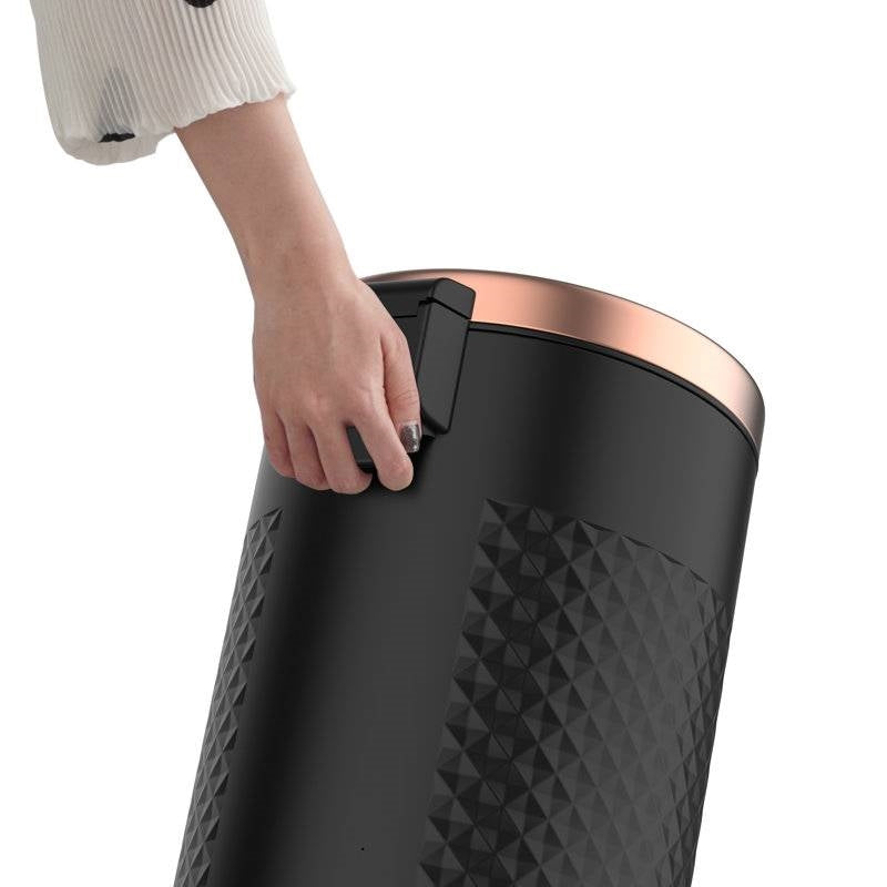 Hands Free Black Gold Metal Step On Trash Can 8 Gallons lid being lifted by hand for easy access.