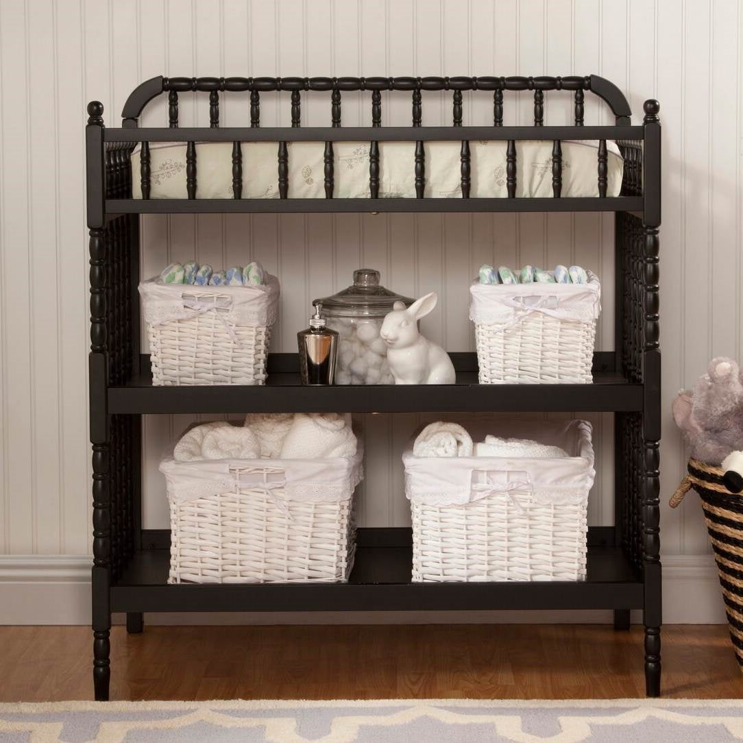 Changing Table Black Wood Finish with 1 inch Waterproof Pad featuring storage baskets and baby items.