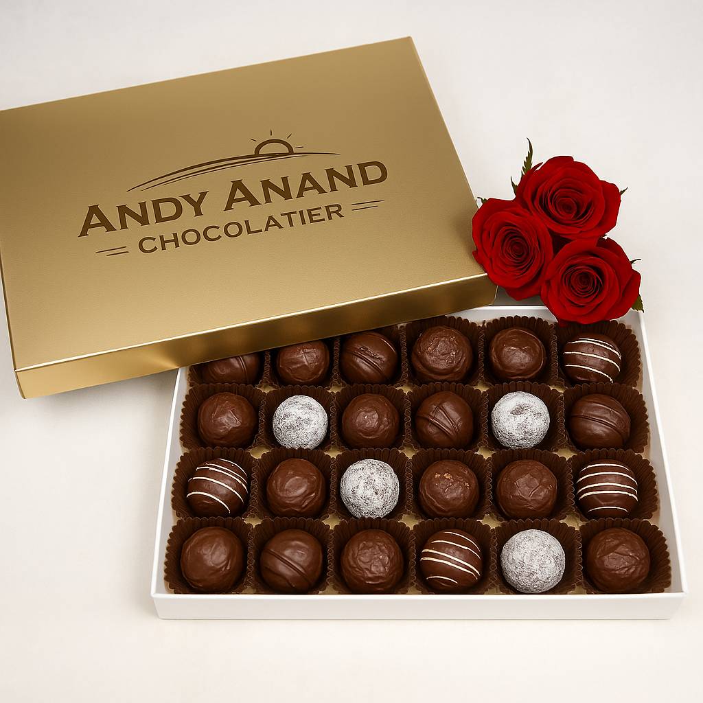 Box of chocolates from Andy Anand Chocolatier with red roses on a white background