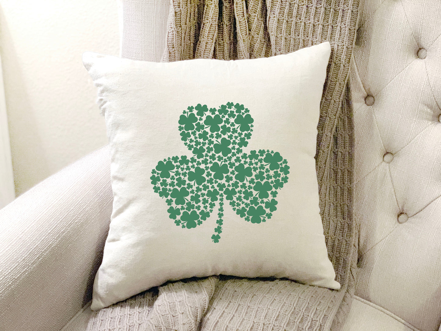 Big Shamrock St Patrick's Day Pillow Cover featuring green shamrock design on a cream pillow.